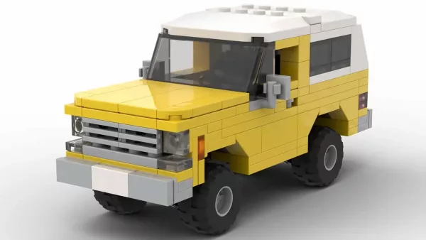 LEGO GMC Jimmy 78 scale brick model in yellow color on white background