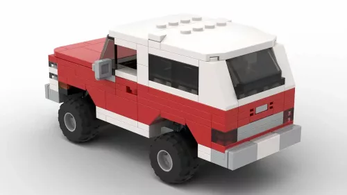 LEGO GMC Jimmy 86 scale brick model in two tone red and white color scheme on white background rear view angle