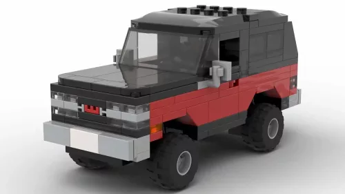 LEGO GMC Jimmy 90 scale brick model in two tone red and black color scheme on white background