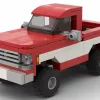 LEGO GMC C1500 Sierra Classic 75 scale brick model in two tone red and white paint scheme on white background