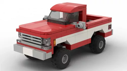 LEGO GMC C1500 Sierra Classic 75 scale brick model in two tone red and white paint scheme on white background