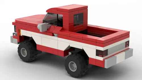 LEGO GMC C1500 Sierra Classic 75 scale brick model in two tone red and white paint scheme on white background rear view angle