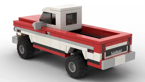 LEGO GMC K1500 72 scale brick model in two tone red and white paint scheme on white background rear view angle