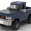 LEGO GMC K1500 Sierra 4x4 86 scale brick model in dark blue color on white background