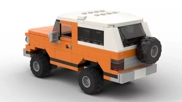 LEGO Dodge Ramcharger 77 scale brick model in orange color on white background rear view angle